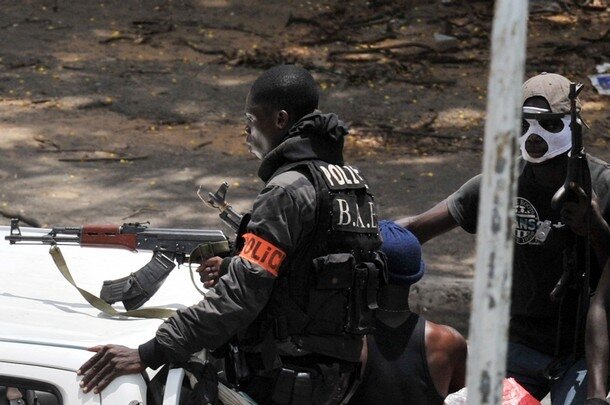 Pro-Gbagbo militiamen sit on the back of