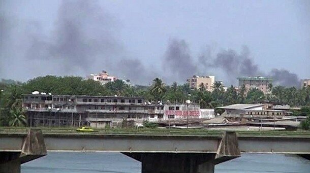 Still image from video shows smoke rising from the city centre of Abidjan