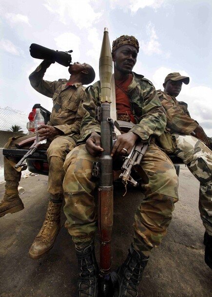 Forces loyal to Ivorian presidential claimant Alassane Ouattara prepare to head to the frontline in the capital Abidjan