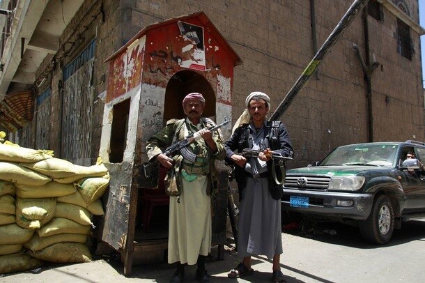 Guards stand guard at a blockade outside the house of tribal leader Shiekh Sadiq al-Ahmar in Sanaa