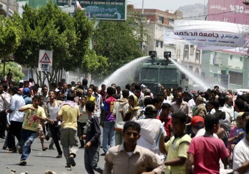 Police use a water cannon to disperse anti-government protesters demanding the ouster of Yemen's President Saleh in Taiz