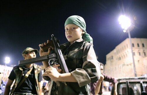 File photo of a boy posing with a gun in Tripoli
