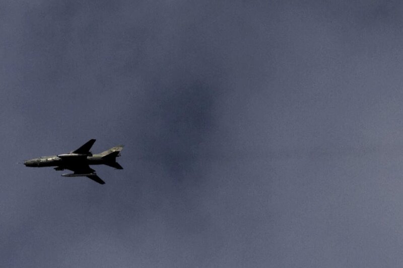 A Libyan MIG fighter jet flies over the