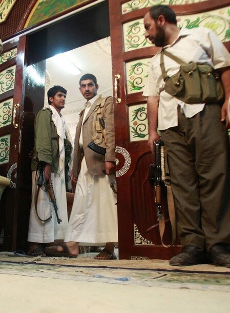 Bodyguards stand guard inside the house of tribal leader Shiekh Sadiq al-Ahmar in Sanaa during clashes between tribesmen loyal to him and police outside the house in Sanaa
